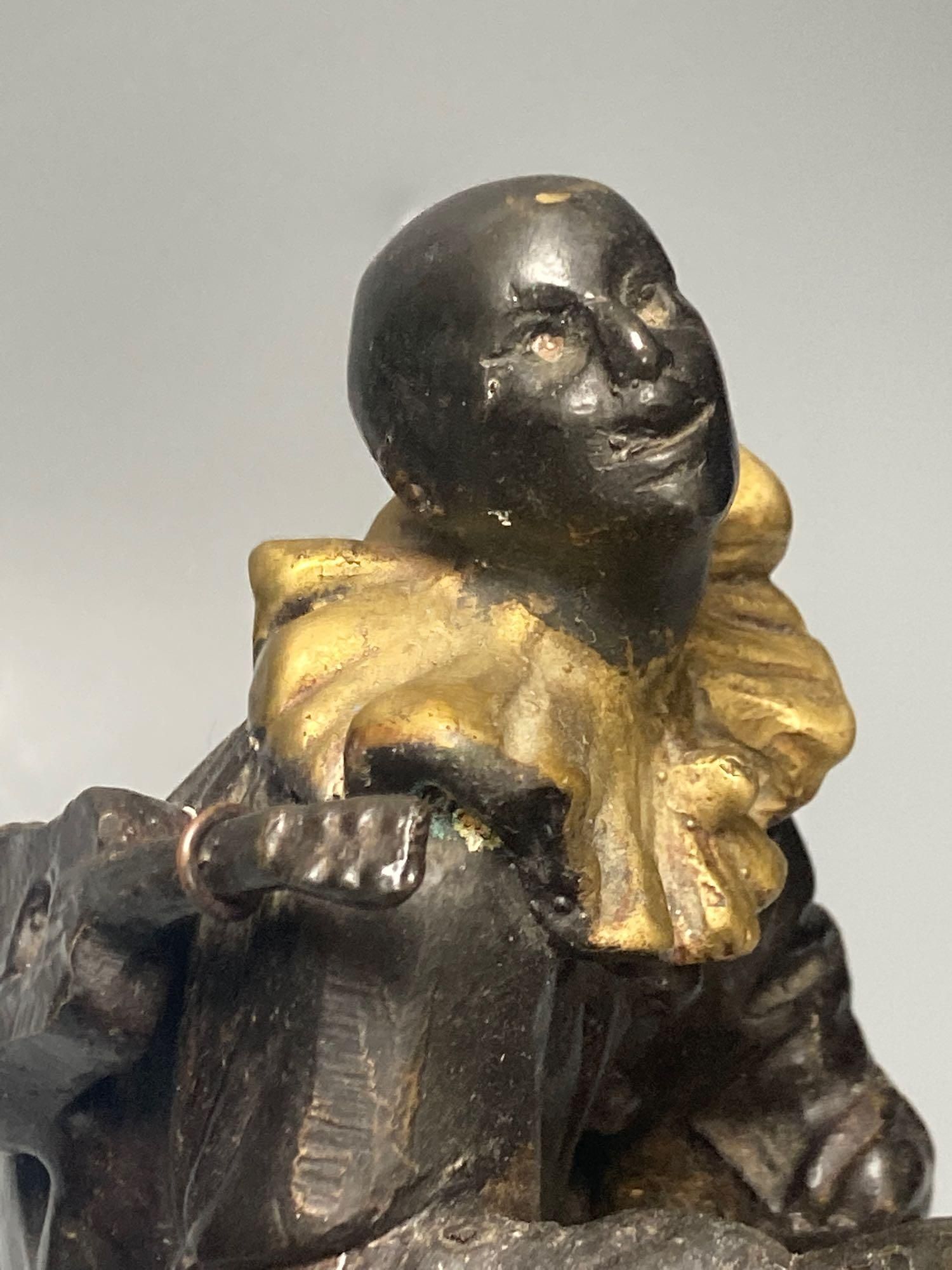 After A. Colinet bronze of Pierrot on a quatre moon, 33cm. high